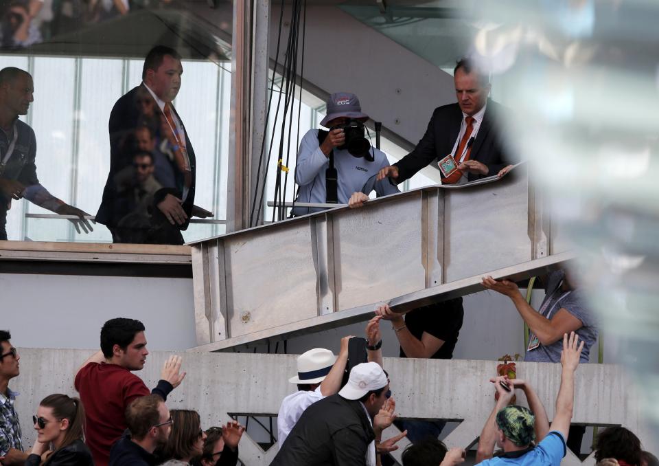 Security members remove a metal structure which collapsed in the tribune on the Philippe Chartier tennis court during the men's quarter-final match between Tsonga of France and Nishikori of Japan during the French Open tennis tournament in Paris