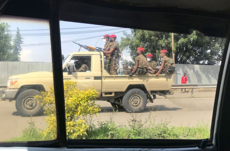 Ethiopian military ride on their pick-up truck as they patrol the streets following protests in Addis Ababa