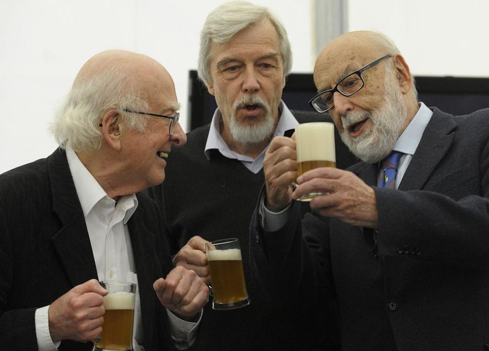 cientists Belgian Francois Englert (R), British Peter Higgs (L) and director general of CERN, German Rolf Heuer (C) drink beers after a meeting with students of the Faculty of Science in Oviedo, on October 24, 2013,