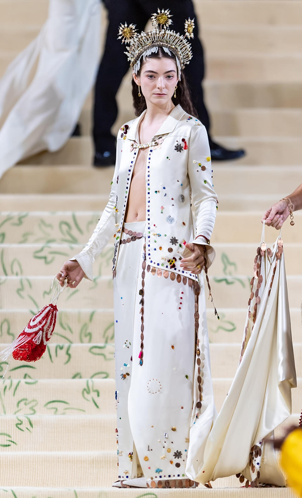 Person in an embellished white outfit with headdress at an event