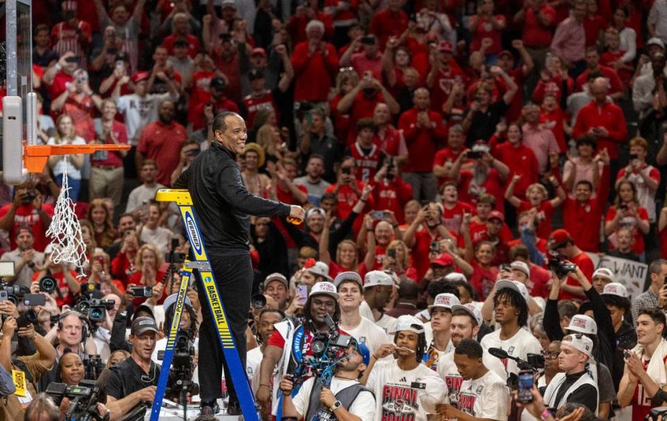 N.C. State coach Kevin Keatts acknowledges fans as he climbs the ladder to cut down the net following the Wolfpack’s 76-64 victory over Duke, clinching the NCAA South Regional final and securing a spot in the Final Four on Sunday, March 31, 2024 at the American Airlines Center in Dallas, Texas.