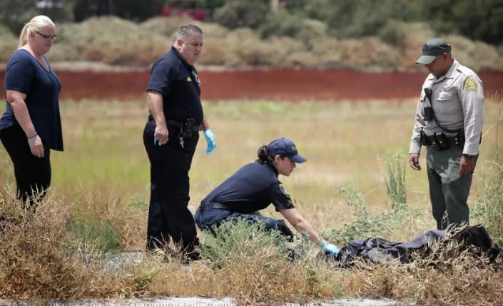 PICO RIVERA-CA-JUNE 22, 2022: The remains of two dogs are removed from the scene where a woman and her two dogs were killed by an apparent lightning strike along the San Gabriel River & Bike Trail in Pico Rivera on Wednesday, June 22, 2022. (Christina House / Los Angeles Times)
