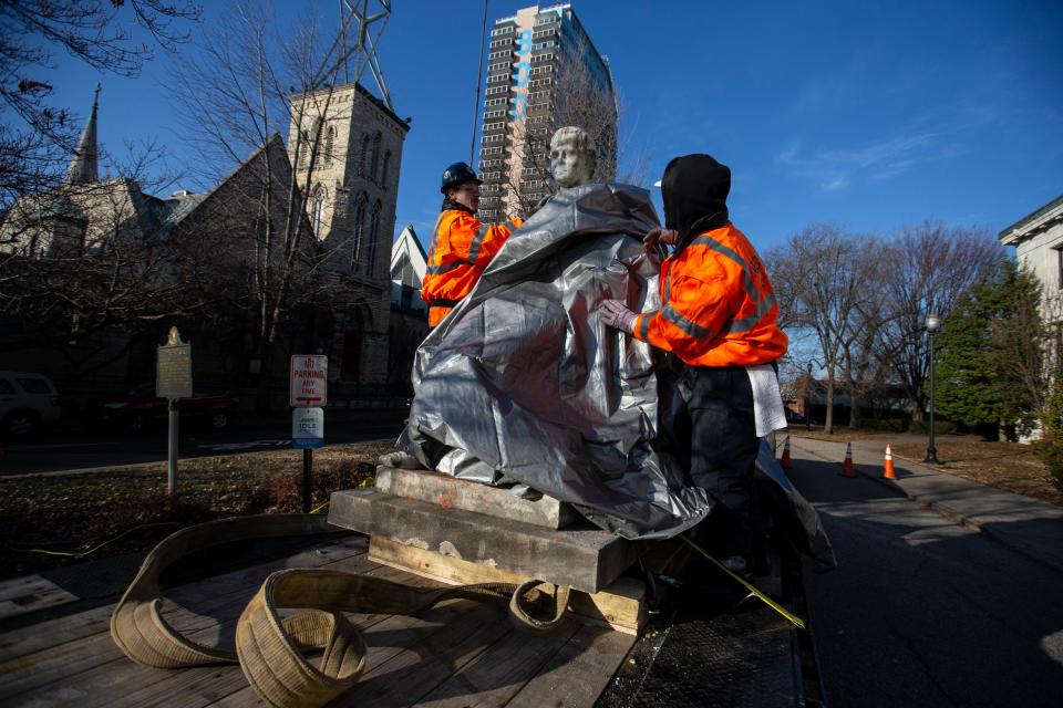 A crew from National Environmental Contracting covered the face of the controversial statue of George D. Prentice before taking it from the front of the Louisville Free Public Library on Dec. 11, 2018.
(Photo: By Pat McDonogh, Courier Journal)