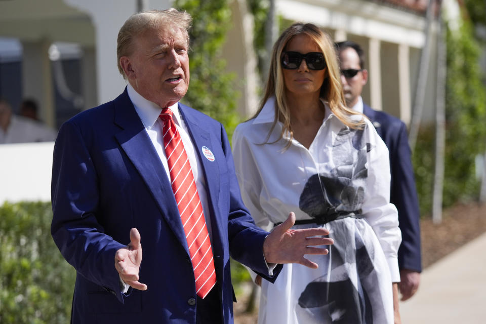 Republican presidential candidate former President Donald Trump talks as former first lady Melania Trump listens, as they leave after voting in the Florida primary election in Palm Beach, Fla., Tuesday, March 19, 2024. (AP Photo/Wilfredo Lee)