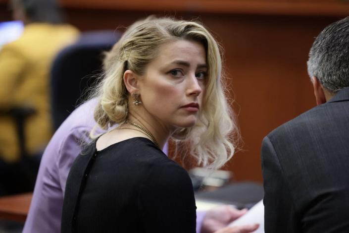 <div class="inline-image__caption"><p>Amber Heard waits before the jury said that they believe she defamed ex-husband Johnny Depp, while announcing split verdicts in favor of both her ex-husband Johnny Depp and Heard on their claim and counter-claim in the <em>Depp v. Heard</em> civil defamation trial at the Fairfax County Circuit Courthouse in Fairfax, Virginia, on June 1, 2022. </p></div> <div class="inline-image__credit">Evelyn Hockstein/AFP/Getty</div>