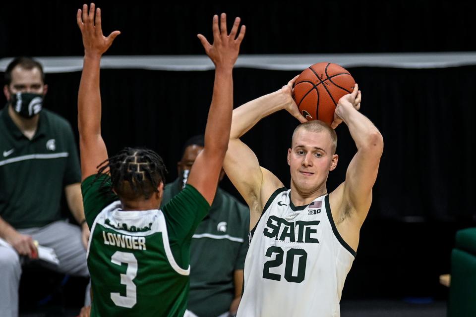 Michigan State's Joey Hauser, right, looks to pass as Eastern Michigan's Drew Lowder defends during the second half on Wednesday, Nov. 25, 2020, at the Breslin Center in East Lansing.