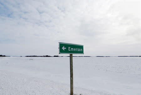 A sign post for the small border town of Emerson, near the Canada-U.S border crossing where refugees make their way often on foot into the province, is seen in Emerson, Manitoba, Canada, February 1, 2017. REUTERS/Lyle Stafford