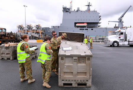 Emergency relief supplies for those affected by Cyclone Debbie are loaded onto the Royal Australian Navy Ship HMAS Choules at the Port of Brisbane in Australia, March 29, 2017. AAP/Dave Hunt/via REUTERS