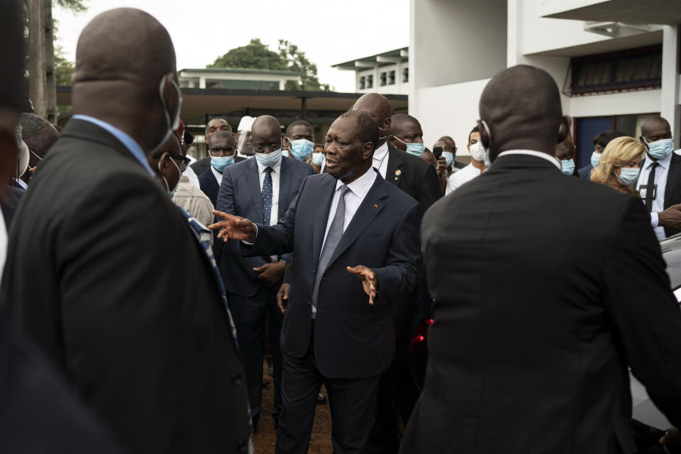 Ivory Coast President Alassane Ouattara leaves after voting in a polling station during presidential elections in Abidjan, Ivory Coast, Saturday, Oct. 31, 2020. Tens of thousands of security forces deployed across Ivory Coast on Saturday as the leading opposition parties boycotted the election, calling President Ouattara's bid for a third term illegal. (AP Photo/Leo Correa)