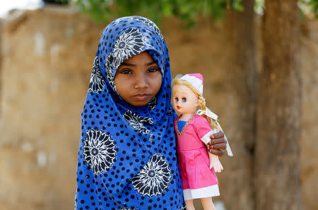 Afaf Hussein, 10, who is malnourished, holds her doll near her family's house in the village of al-Jaraib, in the northwestern province of Hajjah, Yemen, February 20, 2019. Afaf, who now weighs around 11 kg and is described by her doctor as "skin and bones", has been left acutely malnourished by a limited diet during her growing years and suffering from hepatitis, likely caused by infected water. She left school two years ago because she got too weak. REUTERS/Khaled Abdullah