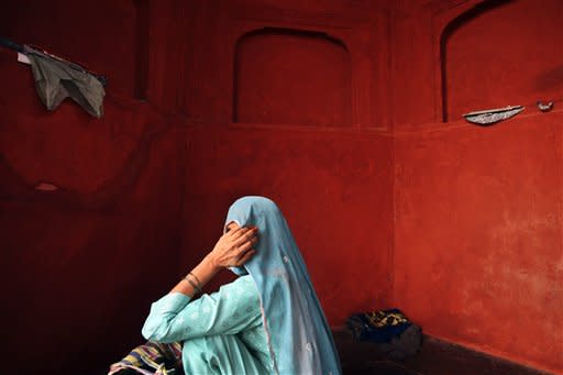 An Indian Muslim women sits inside the the Jama (Grand) mosque on the first Friday of Ramadan in New Delhi, India, Friday, July 27, 2012. Muslims throughout the world are marking the month of Ramadan, the holiest month in Islamic calendar where devout fast from dawn till dusk. (AP Photo/Tsering Topgyal)