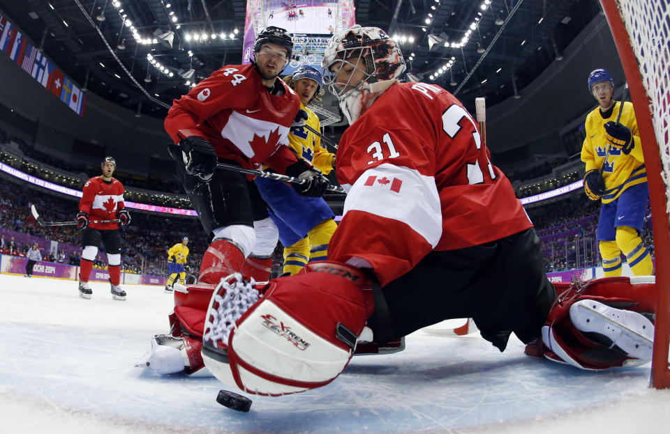 Canada goaltender Carey Price makes a save during the first period of the men's gold medal ice hockey game against Sweden at the 2014 Winter Olympics, Sunday, Feb. 23, 2014, in Sochi, Russia. (AP Photo/Julio Cortez, Pool)