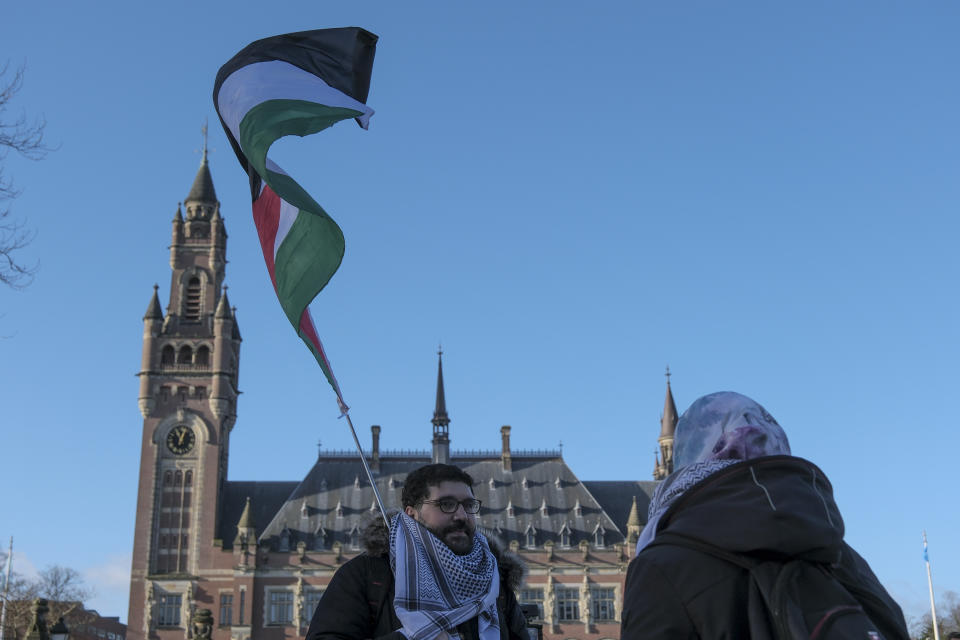 Protesters gather outside the Peace Palace, which houses the International Court of Justice, or World Court, in The Hague, Netherlands, Friday, Jan. 26, 2024. Israel is set to hear whether the United Nations' top court will order it to end its military offensive in Gaza during a case filed by South Africa accusing Israel of genocide. (AP Photo/Patrick Post)