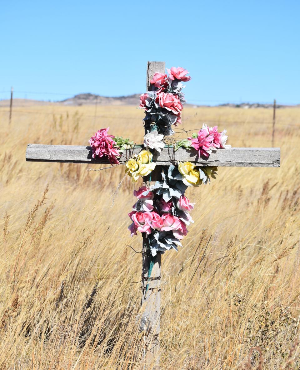 A wooden cross marks where two young women were killed in a 2021 crash involving an impaired driver along U.S. Highway 287 near Livermore on Oct. 19. The highway's 30-mile stretch from Colorado14 to the Wyoming border has a history of fatal crashes.