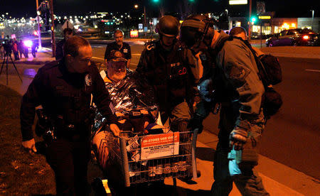 Patrick Carnes is evacuated in a Walmart cart by SWAT medics from the scene of a shooting at a Walmart where Carnes was shopping in Thornton, Colorado November 1, 2017. REUTERS/Rick Wilking