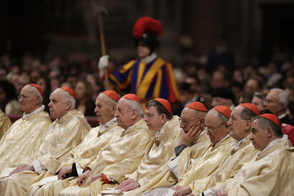 Cardinals sit as Pope Francis celebrates Christmas Eve Mass in St. Peter's Basilica at the Vatican, Tuesday, Dec. 24, 2019. (AP Photo/Alessandra Tarantino)