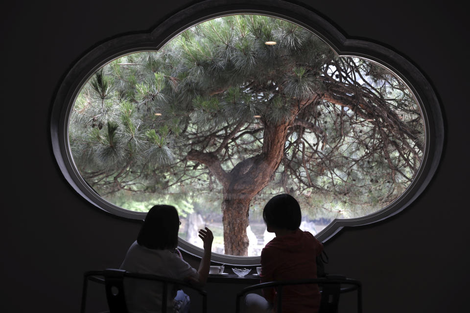 Visitors enjoy the scene from a window of the Xiangshan hotel designed by Chinese-American architect I.M. Pei and built in 1982 in Beijing, China on Friday, May 17, 2019. Pei, the globe-trotting architect who revived the Louvre museum in Paris with a giant glass pyramid and captured the spirit of rebellion at the multi-shaped Rock and Roll Hall of Fame, has died at age 102, a spokesman confirmed Thursday. (AP Photos/Ng Han Guan)