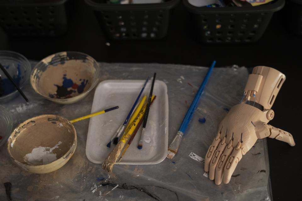 A prosthetic hand made with a 3D printer sits before being painted at the Manos de Heroes foundation headquarters in downtown Montevideo, Uruguay, Friday, April 14, 2023. Since 2020, the foundation has provided more than 100 free prostheses, most of them for families in vulnerable situations. (AP Photo/Matilde Campodonico)