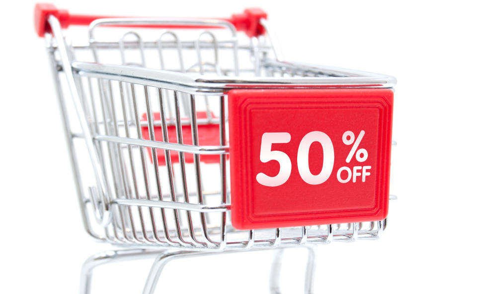 A shopping trolley with a sign saying "50 per cent off".