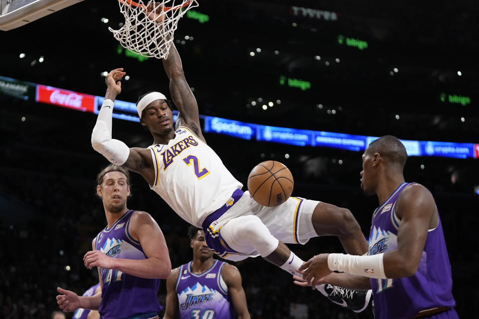 Los Angeles Lakers forward Jarred Vanderbilt, top, dunks as Utah Jazz forward Kelly Olynyk, left, guard Ochai Agbaji, center, and guard Kris Dunn defend during the first half of an NBA basketball game Sunday, April 9, 2023, in Los Angeles. (AP Photo/Mark J. Terrill)