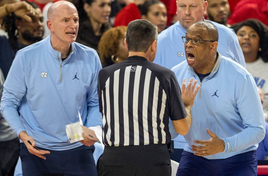 North Carolina coach Hubert Davis urges officials to call a technical foul on N.C. State’s Ernest Ross (24), when he hung on the rim late in the second half on Sunday, February 19, 2023 at PNC Arena in Raleigh, N.C.