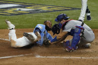 Tampa Bay Rays' Manuel Margot is tagged out at home by Los Angeles Dodgers catcher Austin Barnes trying to steal during the fourth inning in Game 5 of the baseball World Series Sunday, Oct. 25, 2020, in Arlington, Texas. (AP Photo/Tony Gutierrez)