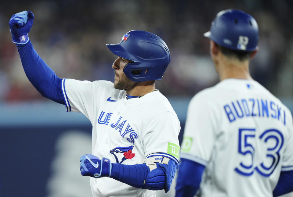 Toronto Blue Jays' George Springer (4) celebrates his RBI single against the Philadelphia Phillies during the sixth inning of a baseball game in Toronto, Tuesday, Aug. 15, 2023. (Nathan Denette/The Canadian Press via AP)