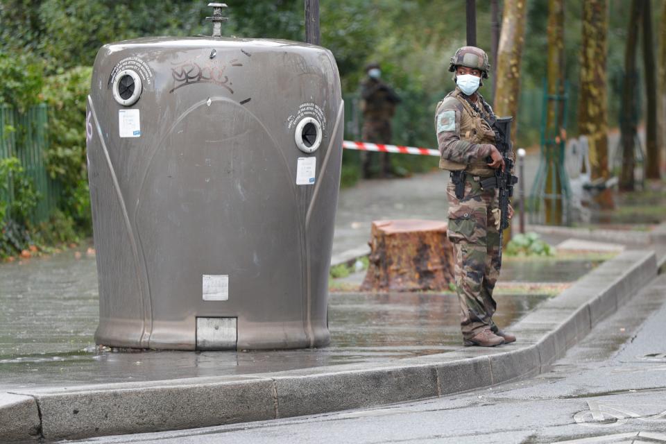 An armed French soldier stands guard near the area after several people were injured near the former offices of the French satirical magazine Charlie Hebdo following an attack by a man wielding a knife in the capital Paris on September 25, 2020. - Four people were injured, two seriously, in a knife attack in Paris on September 25, 2020, near the former offices of French satirical magazine Charlie Hebdo, a source close to the investigation told AFP. Two of the victims were in a critical condition, the Paris police department said, adding two suspects were on the run. The stabbing came as a trial was underway in the capital for alleged accomplices of the authors of the January 2015 attack on the Charlie Hebdo weekly that claimed 12 lives. (Photo by GEOFFROY VAN DER HASSELT / AFP) (Photo by GEOFFROY VAN DER HASSELT/AFP via Getty Images)