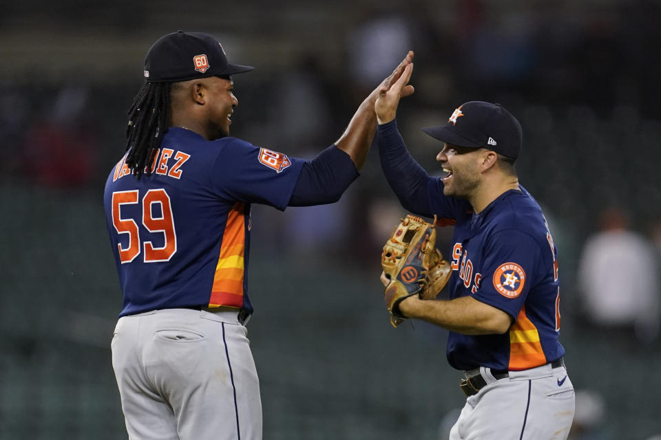 Houston Astros pitcher Framber Valdez (59) celebrates with Jose Altuve after beating the Detroit Tigers 7-0 in a baseball game in Detroit, Monday, Sept. 12, 2022. (AP Photo/Paul Sancya)