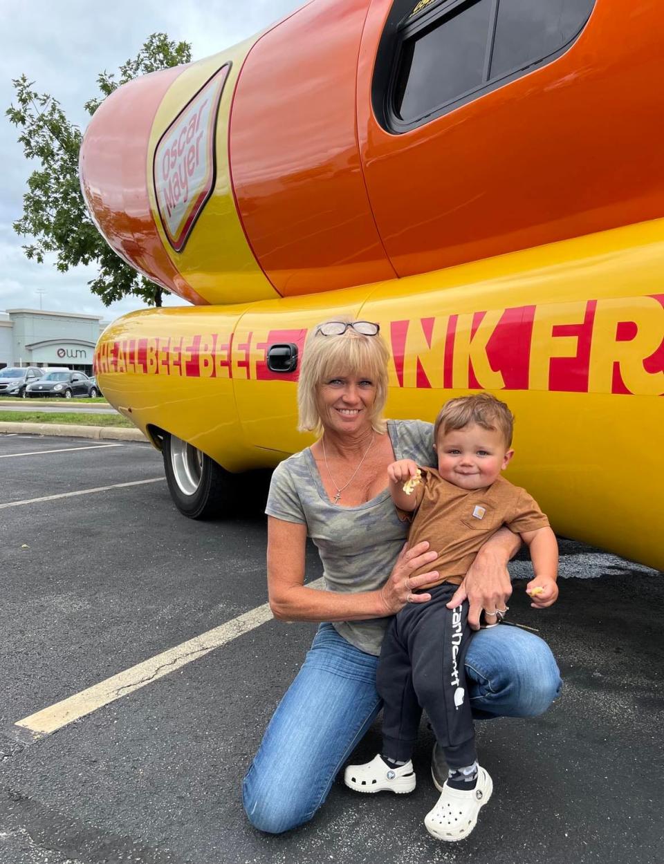 Youngstown area residents pose in front of the Oscar Mayer Frankmobile on Wednesday afternoon. The unique vehicle will be in downtown Canton on Friday.