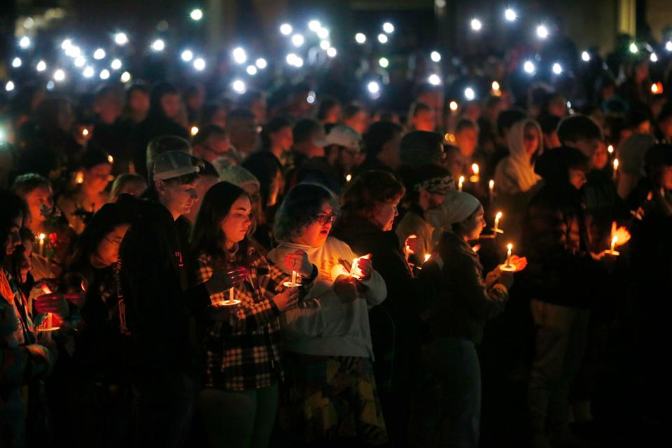 Umass Dartmouth students and staff hold candles during a candlelight vigil to honor Frankie Petillo Jr. who died after being hit by a car, and Alexandra Landra who died unexpectedly in a separate incident.