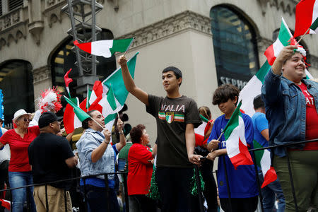 People wave flags during the 74th Annual Columbus Day Parade in Manhattan, New York, U.S., October 8, 2018. REUTERS/Shannon Stapleton