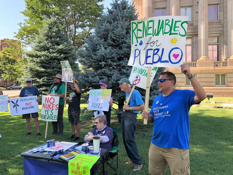 Jamie Valdez (right), a community organizer for Mothers Out Front Colorado, rallies outside the Pueblo County Courthouse with fellow members of the Nuclear-Free Pueblo coalition on Saturday, June 8, 2023.