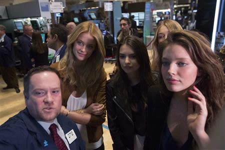 Goldman Sachs Specialist trader Michael Shearin speaks with 2014 Sports Illustrated Swimsuit Models Kate Bock, Emily Ratajkowski, Gigi Hadid and Emily DiDonato (L-R) on the floor of the New York Stock Exchange February 13, 2014. REUTERS/Brendan McDermid