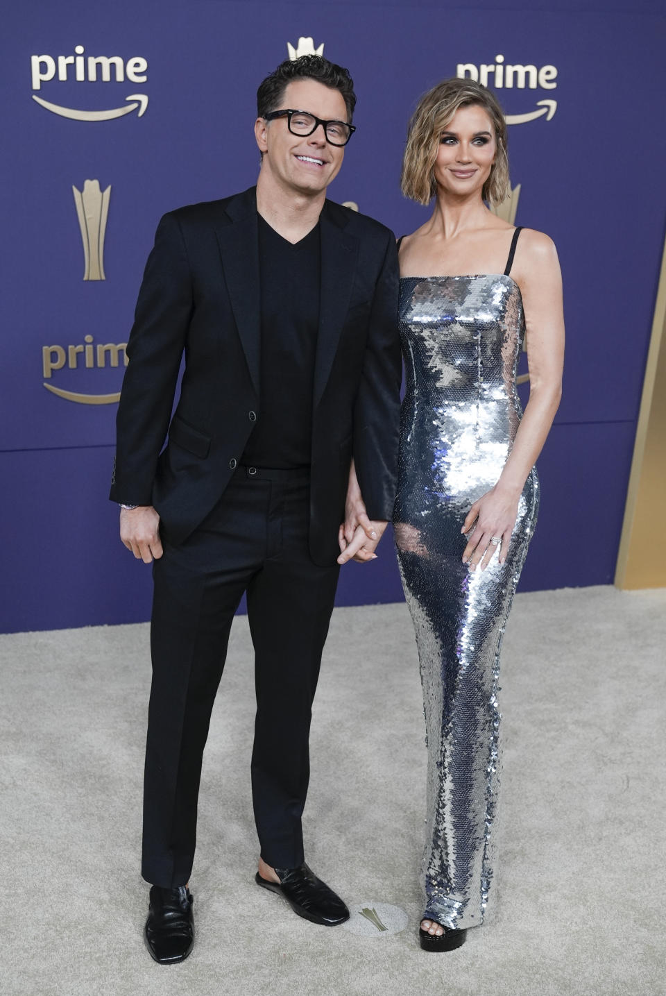 Bobby Bones, left, and Caitlin Parker arrive at the 59th annual Academy of Country Music Awards on Thursday, May 16, 2024, at the Ford Center in Frisco, Texas. (AP Photo/LM Otero)