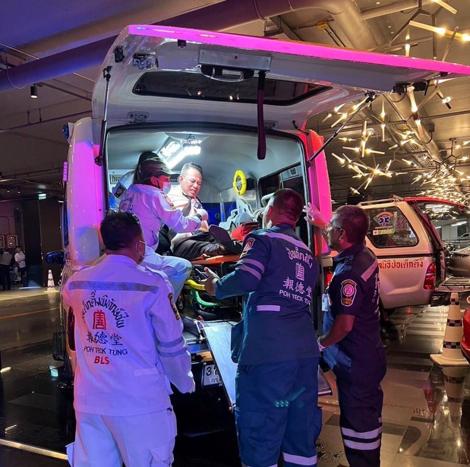 An injured shopper is treated as locals fled from a mall amid a shooting in Bangkok, Thailand