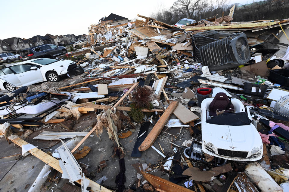 Debris covers the area around homes destroyed in the West Creek Farms neighborhood on Sunday, Dec. 10, 2023, Clarksville, Tenn. Central Tennessee residents and emergency workers are continuing the cleanup from severe weekend storms. (AP Photo/Mark Zaleski)