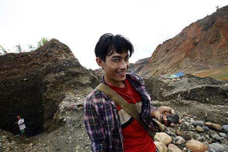 Too Aung, a 30-year-old hand-picker, shows the unwashed jade that he just found in a jade mine in Hpakant township, Kachin State July 7, 2013. REUTERS/Minzayar