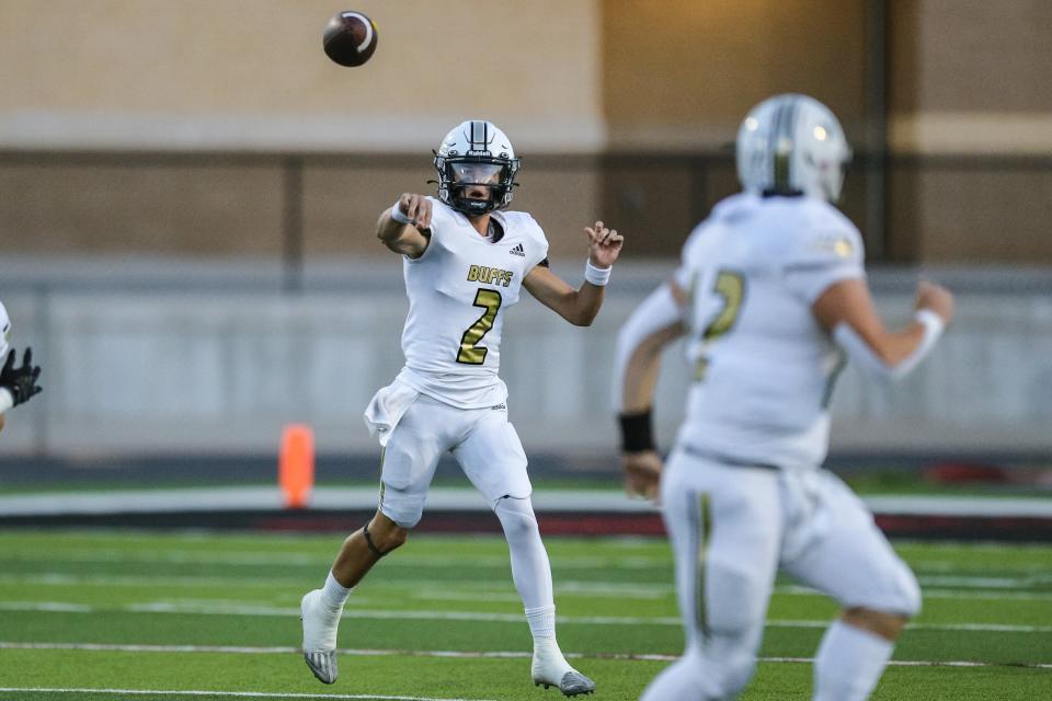 McAlester's Caden Lesnau (2) throws the ball to Lance Stone (12) during a high school football game between the Del City Eagles and the McAlester Buffalos at Robert Kalsu Stadium at Del City High School in Del City on Friday, Sept. 30, 2022.