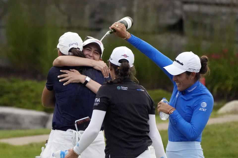 Maria Fassi, right, pours a drink on Cheyenne Knight after Knight and Elizabeth Szokol won the Dow Great Lakes Bay Invitational golf tournament at Midland Country Club, Saturday, July 22, 2023, in Midland, Mich. (AP Photo/Carlos Osorio)