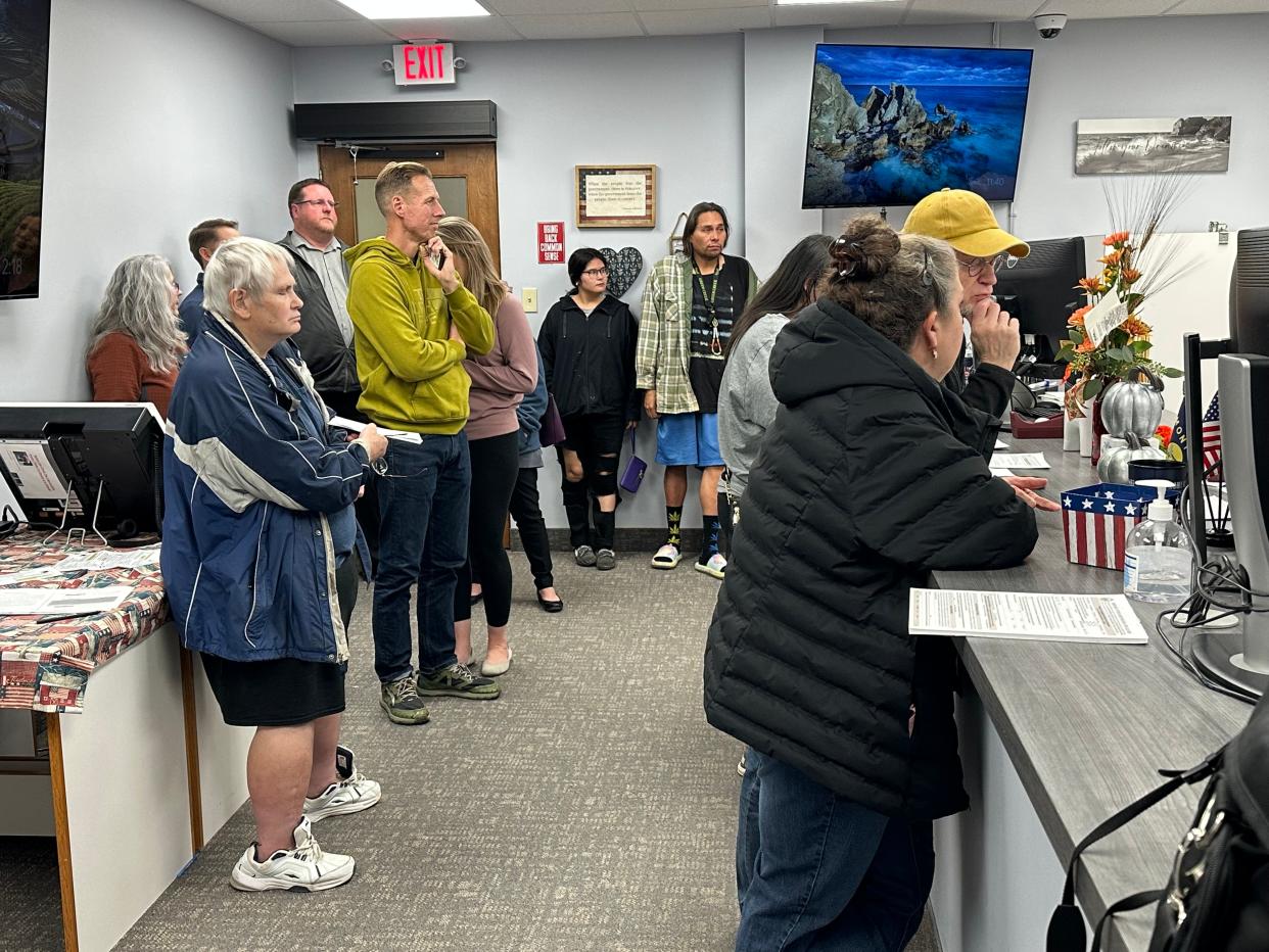 Voters wait to obtain ballots at the Cascade County Elections Office Tuesday evening