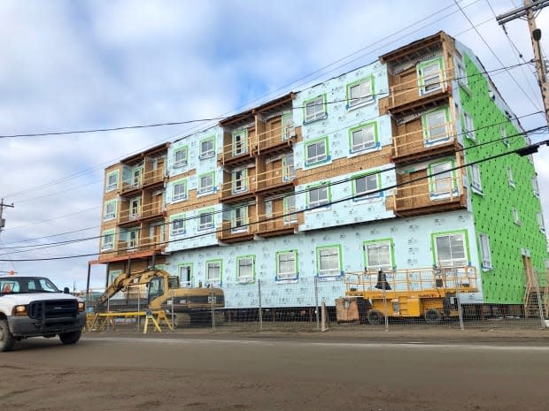 This housing complex is under construction in Iqaluit's downtown core. Tenders for housing projects this summer came back up to 40 per cent over budget, forcing them them to be delayed.  (Beth Brown/CBC - image credit)