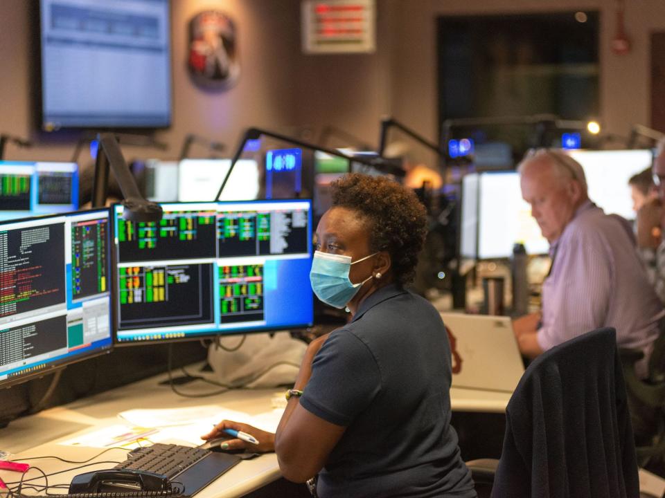 nzinga tull sits at computer in nasa control room working on hubble space telescope