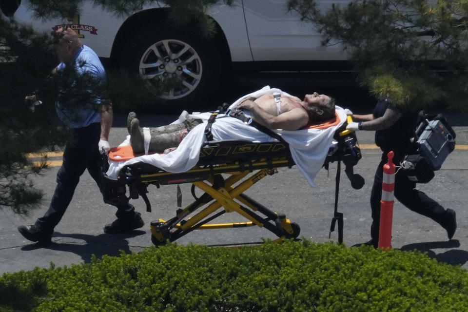 Firefighters rescue a worker after the partial collapse of a building under construction, Friday, June 2, 2023, New Haven, Conn. (Paul Haring via AP)