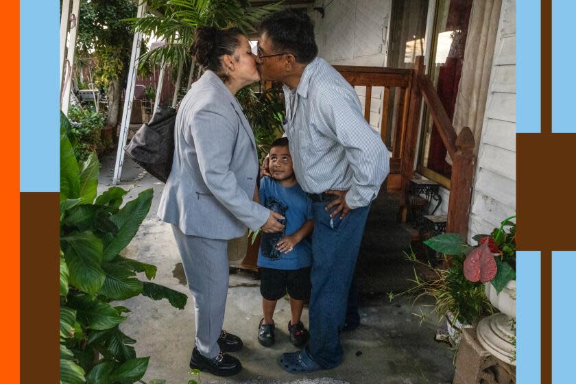 Maria de Pilar Barradas, left, gives a kiss to Alejandro Medel as 4-year-old son Angelo Medel-Barradas stands between them