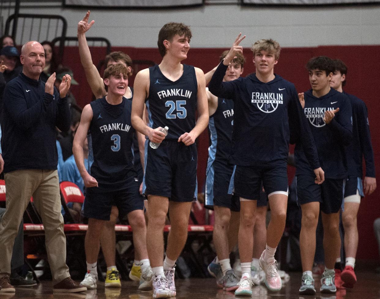 The Franklin High School basketball team, including seniors #3, Bradley Herndon, and #25, Sean O'Leary, was all smiles as the first half ended at Milford, Jan. 26, 2024. Franklin went on to win, 81-53.