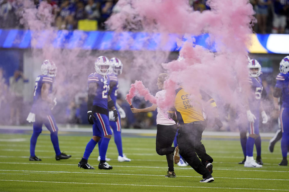 A fan runs onto the field during the second half of an NFL football game between the Los Angeles Rams and the Buffalo Bills Thursday, Sept. 8, 2022, in Inglewood, Calif. (AP Photo/Ashley Landis)