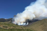 In this photo provided by the Custer Gallatin National Forest, the Robertson Draw fire burns near Red Lodge, Mont., on Monday, June 14, 2021. Authorities warned of extreme wildfire danger in Montana and Wyoming Tuesday as a sweltering heat wave was forecast to intensify across large parts of the two states after already delivering record high temperatures. (Custer Gallatin National Forest via AP)