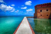 <p><a href="https://www.nps.gov/drto/index.htm" rel="nofollow noopener" target="_blank" data-ylk="slk:Dry Tortugas National Park;elm:context_link;itc:0;sec:content-canvas" class="link "><strong>Dry Tortugas National Park </strong></a></p><p>The Everglades are enormous and cover much of the Southern part of Florida and should definitely be on your list, but if you are looking for a completely unique and cool National Park experience, this one is it. In order to get to Fort Jefferson, you have to take a ferry (that runs once a day) from Key West, or find a seaplane, and head hours out into the middle of the Gulf of Mexico. Once at the fort you can explore the grounds and snorkel along the crystal clear coral reef and see everything from sharks to sea turtles. </p>