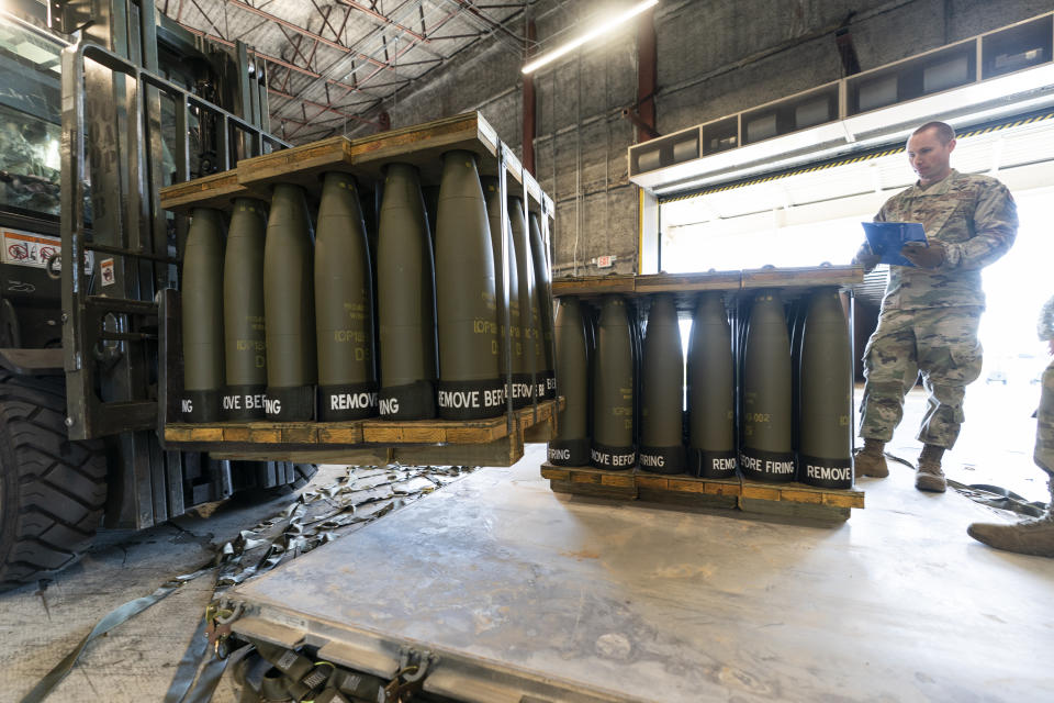 FILE - U.S. Air Force Staff Sgt. Cody Brown, right, with the 436th Aerial Port Squadron, checks pallets of 155 mm shells ultimately bound for Ukraine, April 29, 2022, at Dover Air Force Base, Del. The White House says funding for Ukraine has run out and it has been increasing pressure on Congress to pass stalled legislation to support the war against Russia. On Tuesday, however, President Joe Biden touted a new military aid package worth $200 million for Ukraine. That may seem contradictory, but it’s due to the complex programs used to send aid to Ukraine. (AP Photo/Alex Brandon, File)